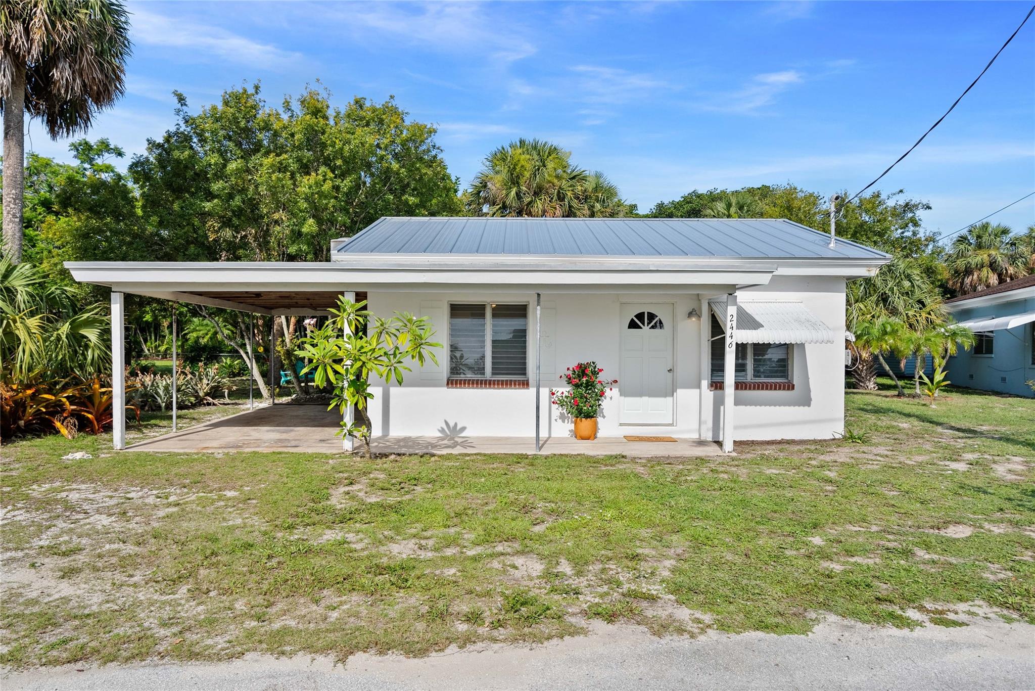Welcome to The Anchor House – a charming coastal cottage just two blocks from the Intracoastal Waterway, with signature anchor shutters and Old Florida flair. This 2-bed, 1-bath home sits high and dry (not in a flood zone) on an oversized R-3 lot, allowing a second dwelling. Just ~1,000 ft from the upcoming Four Fish Yacht Club & Tiki Bar (Q2 2026) and ~1,200 ft to the boat ramp. Room for a hammock, tiki hut, and boat/jet ski storage. Drive your golf cart to beaches, waterfront dining, and Jammin' Jensen on Thursday nights! CBS, new metal roof, LVP flooring, 2023 HVAC, refreshed kitchen/bath, and Benjamin Moore paint inside and out. Sewer connection available; pristine well water for landscaping. Drop anchor & live the dream! Buyer to verify all information, Owner/Agent.