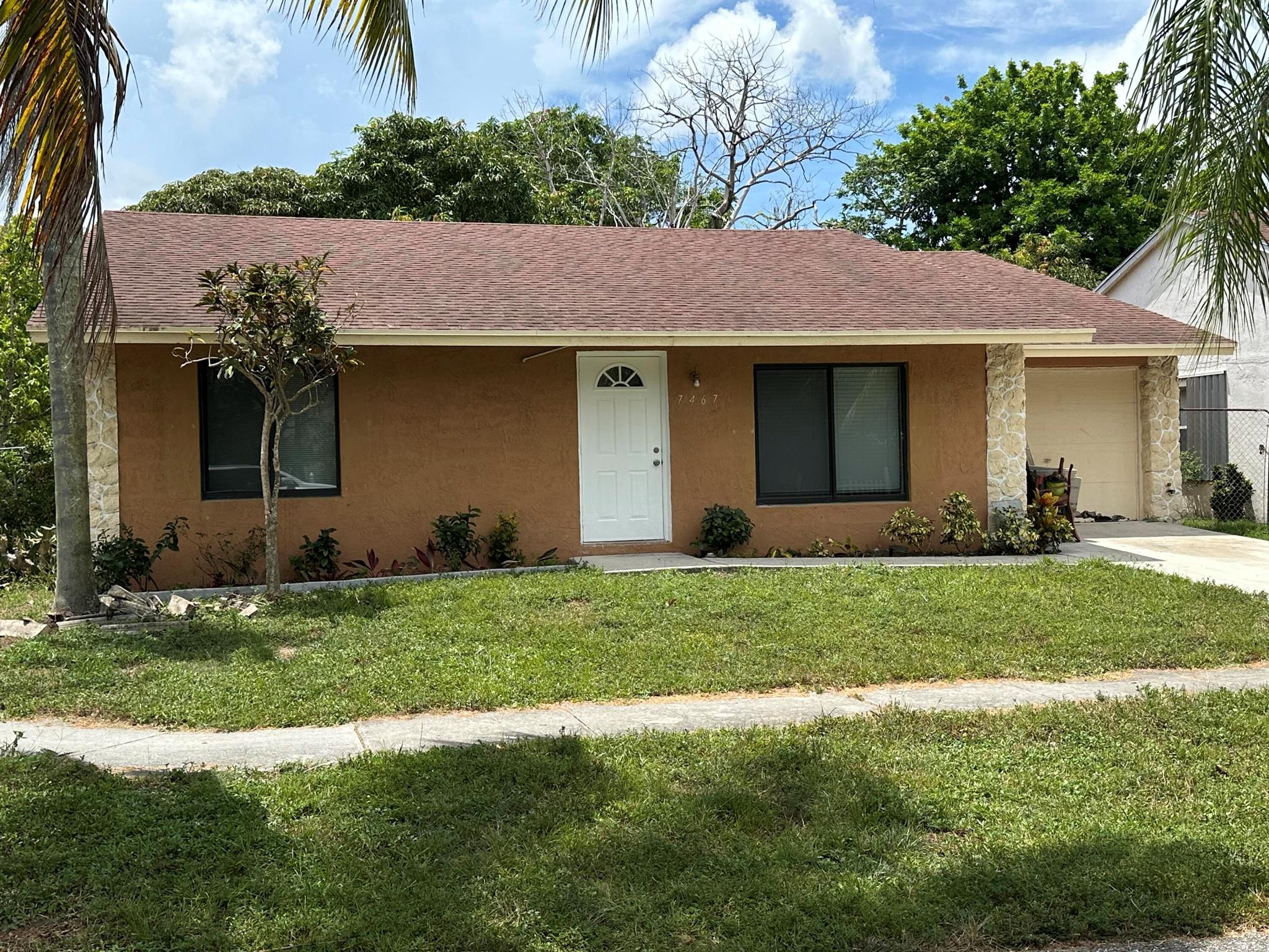 Come see this thoughtfully updated home, ideally located in a welcoming neighborhood with a very low HOA. Step inside to find modern laminate flooring throughout, a stylish kitchen featuring wood cabinetry, granite countertops, and newer appliances, including a gas stove for the home chef.The bathroom has been completely renovated, and the entire home has been freshly painted. Enjoy peace of mind with all impact windows, providing both safety and energy efficiency.Outside, you'll find an expansive backyard filled with mature fruit trees , a private oasis perfect for relaxing, entertaining, or creating lasting memories with family. Don't miss this move-in-ready gem!Garage door will be replaced.