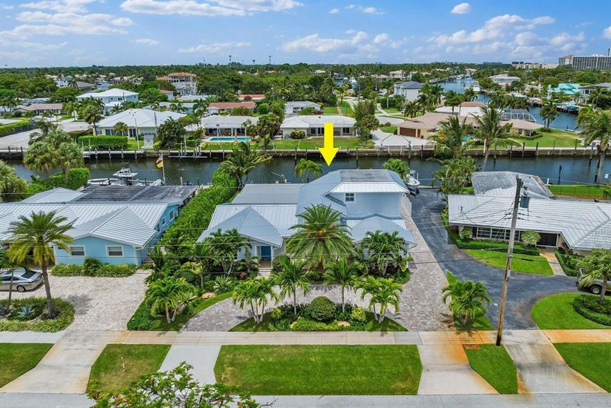 Totally Renovated Deepwater Home on 100' Wide Canal with Private Dockage for up to 70' Boat. No Fixed Bridges & Easy Access to the Intracoastal & Ocean. This Key West Style Home has 3 Bedrooms, 3 Baths & 2 Car Garage. Features include New Metal Roof, Impact Windows & Doors, Plantation Shutters, Wood Plank Tile, Circular Paver Driveway, Hurricane Screened-In Patio & Lush Tropical Landscaping. Open Kitchen with Custom Shaker Cabinets, SS Appliances, Pantry, Beautiful Quartz Countertops, Oversized Island & Backsplash. 1st Floor Spacious Master Suite with Sitting Room & Huge Walk-In Closet. Master Bath with Custom Double Sink Vanity, Large Shower with Quartz Walls, Dual Shower Heads & Frameless Glass.1st Floor Ensuite Guest Rm & 2nd Floor Master Ensuite (Used For Office/Den) with Large Balcony