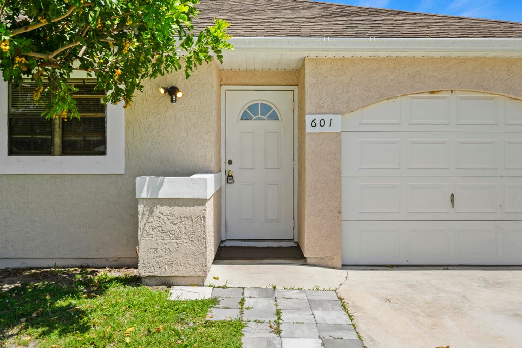 Photo of 601 SW Ester Avenue, Port Saint Lucie, FL 34983 (MLS # B26025852)