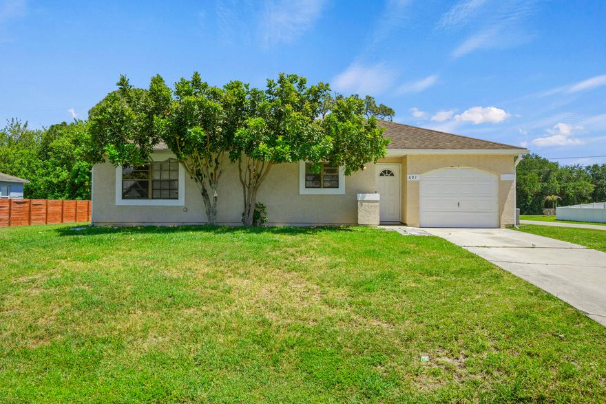 Charming and move-in ready 2BR/1BA home on an oversized corner lot in desirable Port St. Lucie! This cute and inviting home offers a bright, functional layout with comfortable living spaces and abundant natural light throughout. Spacious primary bedroom features a walk-in closet for added storage. Kitchen includes appliances, and washer/dryer are conveniently located in the garage. Newer water heater already in place. Enjoy the extra outdoor space with room to relax, entertain, garden, or add future possibilities. Conveniently located near shopping, dining, parks, schools, and major roadways. Perfect for first-time buyers, seasonal residents, downsizers, or investors looking for value and potential!