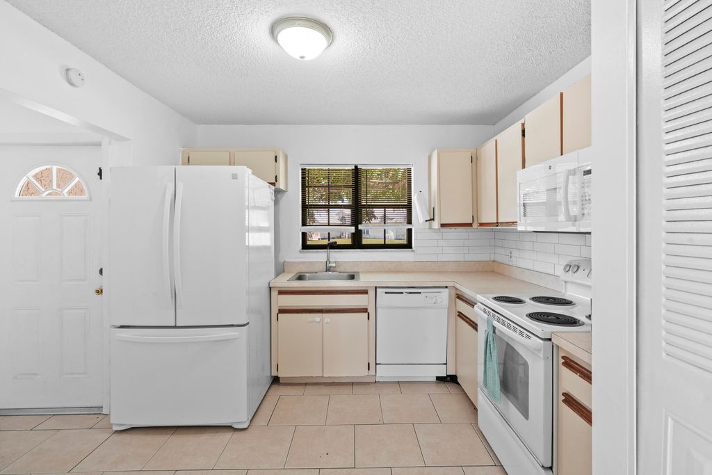 Photo of 601 SW Ester Avenue, Port Saint Lucie, FL 34983 (MLS # B26025852)