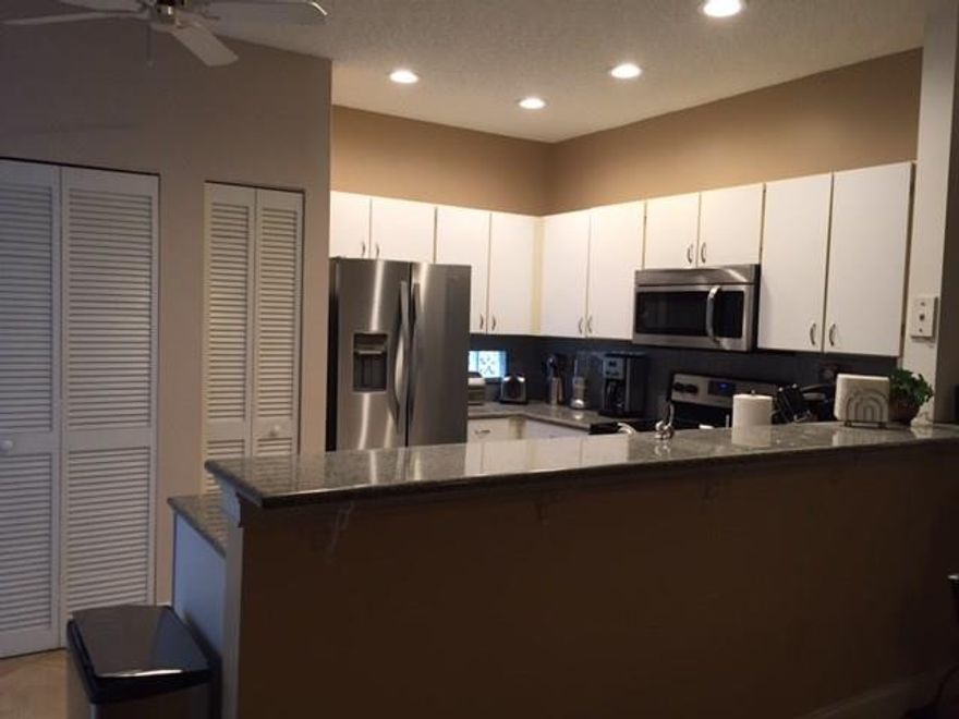 This home shows pride in ownership!  Tile on First Floor and Real Wood on stairs and in all 3 bedrooms. Granite countertops in kitchen, Stainless Steel Appliances 2014 with a fully remodeled Master Bath. Accordion Hurricane Shutters, A/C new 2013.  Perfectly situated and is walking distance to all 3 schools.