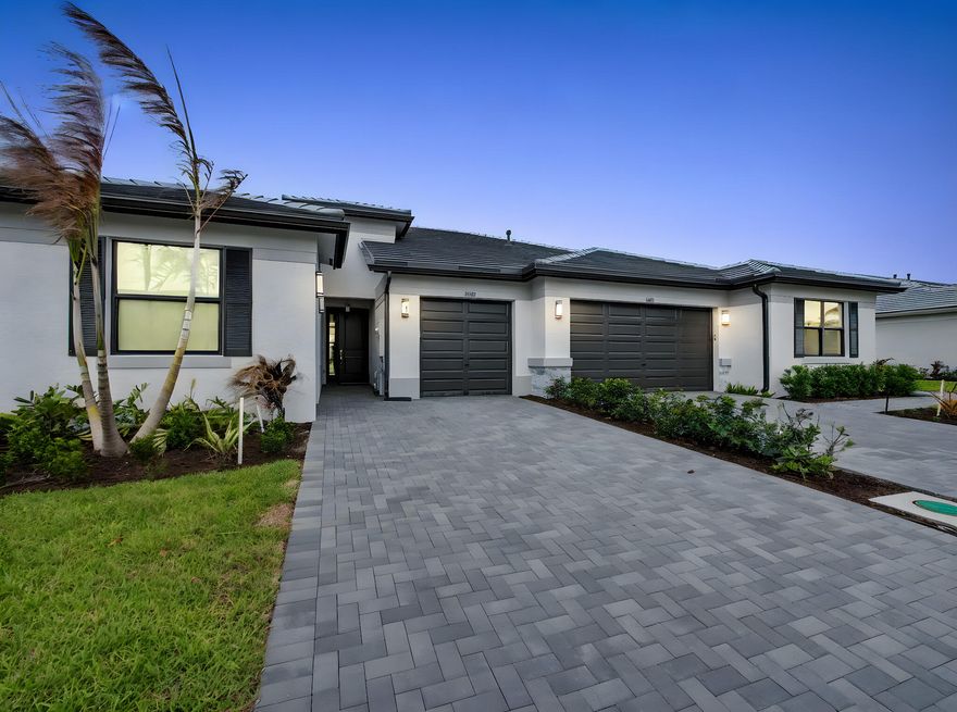 Valencia Parc at Riverland is where you'll find Port St. Lucie's best 55+ lifestyle with a million ways to have fun including a beautiful 38,000-square foot Clubhouse with resort-style amenities. This Areca floorplan includes private views and an open floor plan with matte tile flooring throughout the entire home. The home features high end finishes including impact glass windows, GE gas appliances, tile roof, and recessed LED lighting.  The kitchen includes quartz countertop with a designer marble tile backsplash, painted bright white maple cabinets, and GE stainless-steel appliances with a chimney hood. All bathrooms include high end quartz countertops and painted bright white maple vanity cabinets. Valencia Parc offers access to the amazing facilities found throughout the 4,000 acres of master-planned amenities at Riverland, where bigger is better! Stay fit at the 24-acre Sports & Racquet Club that offers over 80 outdoor sports courts and a 51,000 square-foot Wellness & Fitness Center. At Riverland you'll also find ways to express yourself at the 5-acre Arts & Culture Center, a bustling Town Center, the 12-acre Paseo Park among many future city parks and much, much more! You'll be able to easily access it all with the 5 miles of gorgeously landscaped traffic-free Paseo and greenways that connects everyone and everything throughout Riverland like never before - all that's missing is you! CONTACT FOR MORE DETAILS AND TO SCHEDULE TIME TO PREVIEW.