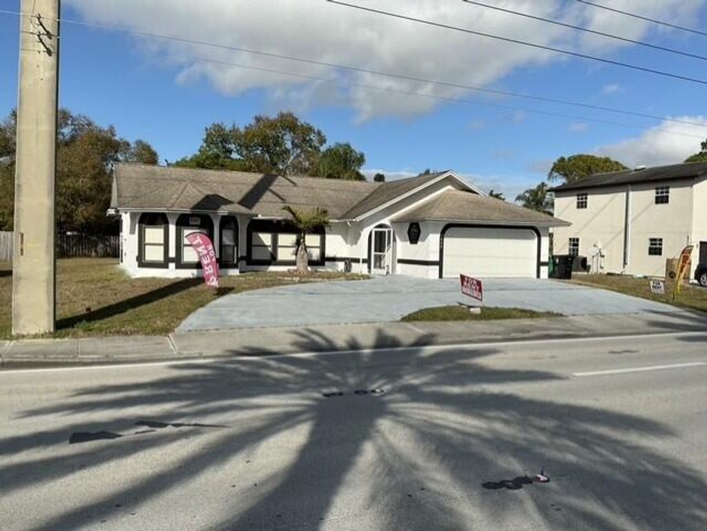 Photo of 557 SE Port St Lucie Boulevard, Port Saint Lucie, FL 34984 (MLS # R11159104)