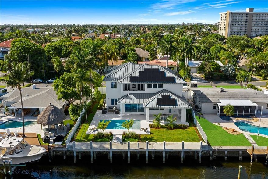 **READY FOR IMMEDIATE OCCUPANCY** New Construction | Coastal Contemporary design. 85' of deep waterfront, a concrete dock, quick ocean access via the Hillsboro Inlet & pvt beach access. Open flr plan features a 2 story foyer, glass encased stairway, dining area, great rm & culinary kitchen w/upgraded appliances, custom Italian cabinetry, gas cook top & walk-in pantry. Multiple doorways open to a covered loggia overlooking a saltwater pool, summer kitchen, lrg. backyard & cabana bathrm. The primary suite boasts a sitting area, 2 enormous walk-in closets & balcony w/Intracoastal views. Additional details include: a home office, solar panels & closet for future elevator. *Opportunity for Seller to assist buyer with reduction in interest rate, additional info available.*  Sq ft from architect