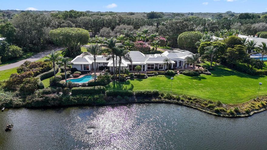 Welcome to 23 Country Road South, nestled within the serene and prestigious Village of Golf. Situated on a 1.23-acre corner lot, this charming residence features five bedrooms and four bathrooms, a sprawling backyard, pool, and cozy patio space ideal for enjoying the South Florida sun. Its prime positioning grants breathtaking views of the scenic pond, inviting you to embrace the serenity of waterfront living. The meticulously landscaped grounds create a serene ambiance, enhancing the allure of this remarkable property. Offering the most prestigious and sought-after location within the Village of Golf, this property affords its residents an unparalleled lifestyle.