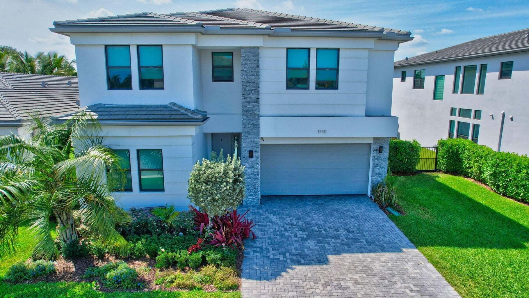 Polynesia model located in the lifestyle community of Lotus, Boca Raton. This house sits on a very quiet lot with a gorgeous salt water pool, lake views and is equipped with a natural gas generator. As you step inside this 5 bedroom, 7 bathroom home you'll notice the high ceilings and gorgeous staircase with glass railing. The open floor plan blends indoor and outdoor living spaces and the gourmet kitchen features all stainless steel appliances, quartz countertops, natural gas stove and eat in kitchen. The main level features one bedroom/office, with en suite bathroom, great room, separate dining room and cabana bathroom.Upstairs you'll find the primary bedroom with 2 en-suite bathrooms and custom walk-in closets, as well as 3 additional bedrooms, 2 of which have en-suite bathrooms.
