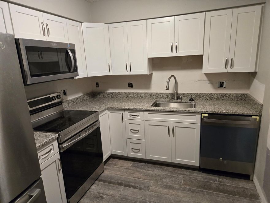 Completely Renovated inside, new tile flooring, new kitchen and appliances. Oversized 2/2 (1200 sq/ft.) with a large fenced yard, access to pool in back yard (with child fence for safety).
 Unit has a 6 x 30 foot side patio with 4 foot privacy wall. Yard is lushly landscaped with areca palms and bamboo that provides privacy from neighbors. Property is well maintained, owner pays water and sewer and trash. Freshly painted inside and out, driveway has parking for up to 6 vehicles. Popcorn ceiling was just removed and replaced with a textured look. All impact windows and sliders throughout. New water heater, washer and dryer, and electrical panel, window dressings provided, has smoke detectors.