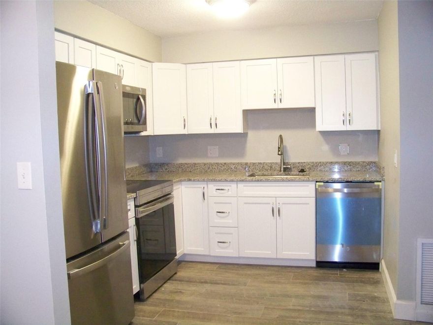 Completely Renovated (40k in updates) inside, new tile flooring, new kitchen and appliances. Oversized 2/2 (1200 sq/ft.) with a large fenced yard, access to pool in back yard (with child fence for safety). Unit has a 6 x 30 foot side patio with 4 foot privacy wall. Yard is lushly landscaped with areca palms and bamboo that provides privacy from neighbors. Property is well maintained, owner pays water and sewer and trash. Freshly painted inside and out, driveway has parking for up to 6 vehicles. Popcorn ceiling was just removed and replaced with a textured look. All impact windows and sliders throughout. New water heater, washer and dryer, and electrical panel, window dressings provided, has smoke detectors. WATER is INCLUDED in Rental Price.