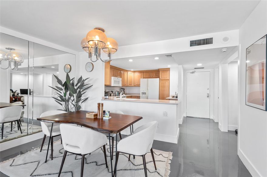 New photos coming soon! Step into this one of kind updated condo. This large 1/1/5 has also has been transformed to have a den perfect for an office or second room for guests. Large balcony with spectacular views of the ocean and intracoastal waterway. Kitchen has open layout perfect for entertaining guest and family. Owner added a dark grey epoxy floor throughout that gives it a modern feel. Unit has impact windows and doors. Full size washer and dryer located in the half bathroom. 1 covered garage parking space. Building has three gyms, game room, large community room, on site manager, car wash area, bike storage, large heated swimming pool, sun deck and private beach access. Building is located in the center of the Galt Mile walking distance to grocery, shops, doctors offices and more!