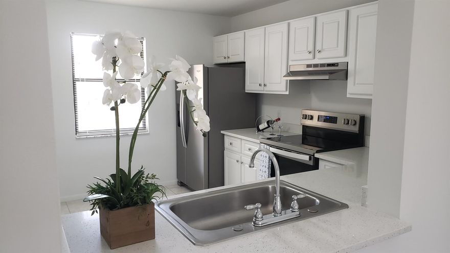 Newly painted, spacious corner unit 2/2 condo with water views from all rooms. Excellent location in the heart of Royal Palm Beach. New flooring. New Whirlpool stainless steel appliances. New quartz countertops. Updated eat-in kitchen with new raised panel cabinet doors. Renovated bathroom. Split bedrooms, master bedroom has own balcony access door. Large walk-in closet. Vaulted ceiling. Laundry inside unit. Lots of natural light. Enclosed Balcony with storage room. 2 community pools. No waiting period to rent. All ages welcome. Pet-friendly community. TV cable, roof and exterior building maintenance included. Lots of guest parking. Close to Village of RPB, parks, library, shopping centers, medical, public golf course, schools, and much more! Minutes from the beach and Florida highways.