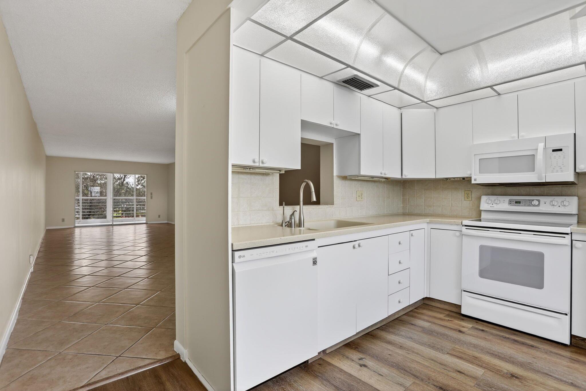 CORNER UNIT! Windows are in the main and 2nd bedroom. Spacious unit over 1200sf with a tranquil secluded LAKE VIEW from the enclosed patio. Patio has sliding doors to allow you to open to allow fresh air in when desired. Washer and dryer are in the unit for only your personal use. Freshly painted in light neutral color.Wynmoor offers a large outdoor pool a few steps from this condo plus a heated pool at the fabulous clubhouse! Also provides an 18 hole golf course, a theater presenting live shows and movies. Enjoy a meal at the onsite restaurant and exercise in the fitness center, resistance walking pool, pickleball courts or in a Zumba class. ShuttleThere are many clubs to participate in and a shuttle bus for your convenience!