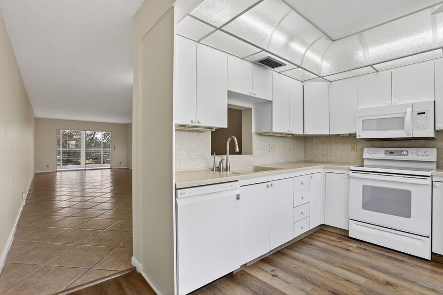 CORNER UNIT!   Windows are in the main and 2nd bedroom.   Spacious unit over 1200sf  with a tranquil secluded LAKE VIEW  from the enclosed patio. Patio has sliding doors to allow you to open to allow fresh air in when desired. Washer and dryer are in the unit for only your personal use.  Freshly painted in light neutral color.Wynmoor offers a large outdoor pool a few steps from this condo plus a heated pool at the fabulous clubhouse!  Also provides an 18 hole golf course, a theater presenting live shows and movies.  Enjoy a meal at the onsite restaurant and exercise in the fitness center, resistance walking pool, pickleball courts or in a Zumba class.    ShuttleThere are many clubs to participate in and a shuttle bus for your convenience!