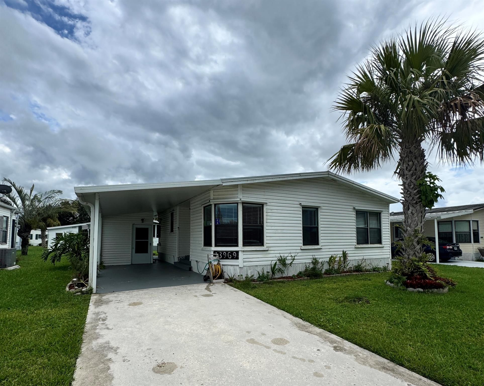 2-bedroom, 2-bath home on a quiet street, conveniently located near the entrance of the desirable 55+ Spanish Lakes Fairways community. The house has no carpet--an open kitchen space with an eat-in kitchen area. The home has a new metal roof in 2024. New A/C and custom-made hurricane shutter panels. This home has two sheds. Home is a fixer-upper. Floors will need some repair, and the primary suite bathroom and guest bedroom will need some drywall work. Price is reflective of repair needs. Lawn care and trash removal are included in the lot rent, as well as an 18-hole golf course, two pools, tennis, pickleball, bocce ball, and shuffleboard: clubhouse, and much more.