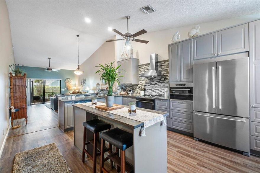 Beautifully Renovated End unit Villa, 55+, two bedroom & two baths and located in the sought after community of Country Greens! From the Private & Tropical Courtyard Entrance you walk into this Open & Spacious Home and gaze at the Custom Dream Kitchen! Offering Modern  Shaker cabinets w/tons of Counters, fancy pull out drawers, Mosaic Tile backsplash, stainless steel appliances & a snack bar. The Huge Principle Suite has a walk-in closet, a Slider to the patio and an Updated En-suite bath. Beautiful Laminate flooring, Vaulted ceilings & an abundance of natural light from the Highly Desireable East-West Exposure. Enjoy the South Florida lifestyle with your 2 Private Patios at the Front & Back of this home! Located close to shopping, dining, entertainment, airports & Trendy Downtown Atlantic