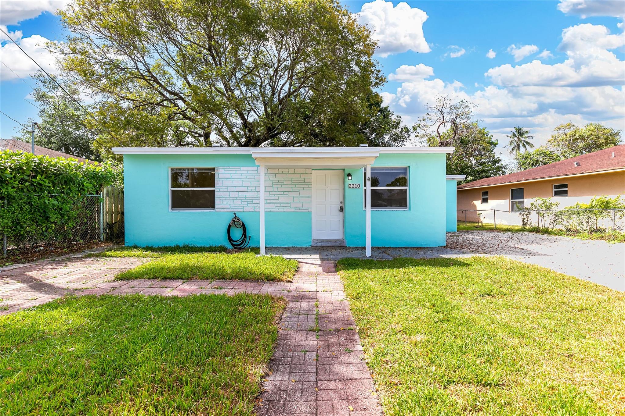Beautiful 2-bedroom, 1-bath home with a spacious, fully fenced yard on a peaceful street. Features a completely remodeled kitchen with modern cabinets. Includes a large central living area and a separate laundry room with washer and dryer hookups, along with ample storage space. The backyard is expansive, boasting mature fruit trees and plenty of shade. Conveniently located near downtown Fort Lauderdale for work, entertainment, and dining, with easy access to I-95, I-595, and Route 1. No HOA approval required.