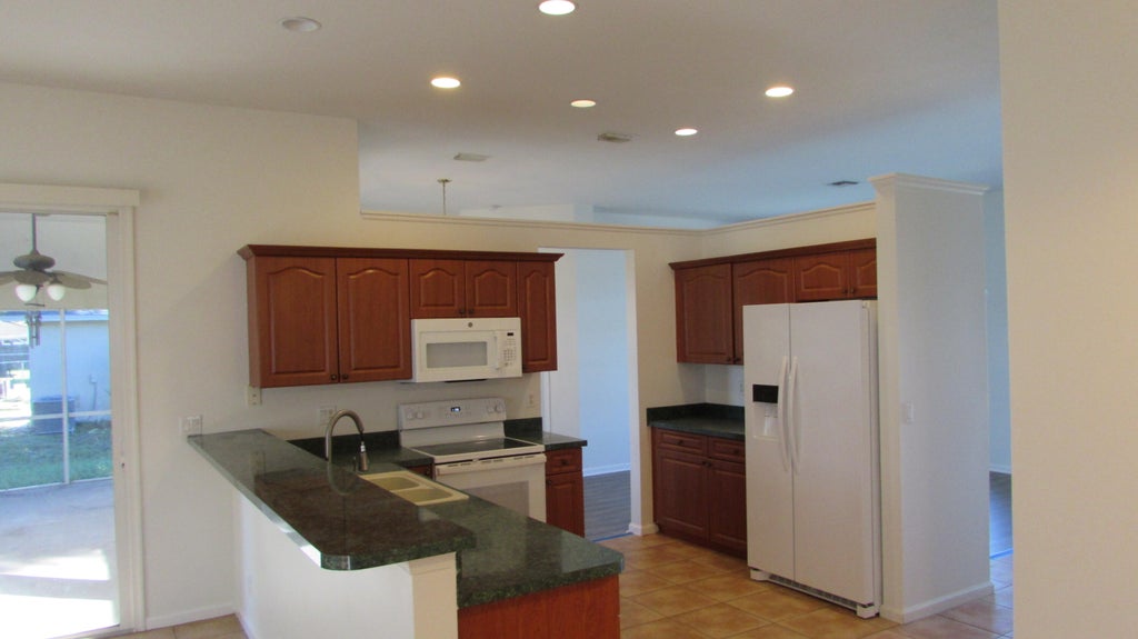 Photo of 2311 SW SUSSET Lane, Port Saint Lucie, FL 34953 (MLS # B26082953)
