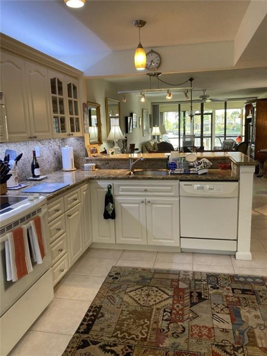 Bring your boat to this beautiful waterfront 2 bedroom, 2 bath unit. Rare to find a ground floor apartment which is handicap accessible. Enjoy your water views from your screened porch overlooking your free boat dock which is included.  The open-ended screen porch with hurricane shutters offers storm protection. Granite kitchen & baths, tile floors, crown molding and recess lighting offer an enjoyable lifestyle.  The entry area of the unit provides an area for your potted plants and landscaping. This is located with the premier, southeast exposure which also provides dockage for larger boats.  This boutique community includes lighted tennis courts, 2 pets, 2 cars allowed with 1 assigned covered, heated pool, hot tub, clubhouse with kitchen, TV, Wi-Fi, fitness gym, TV security & generator.