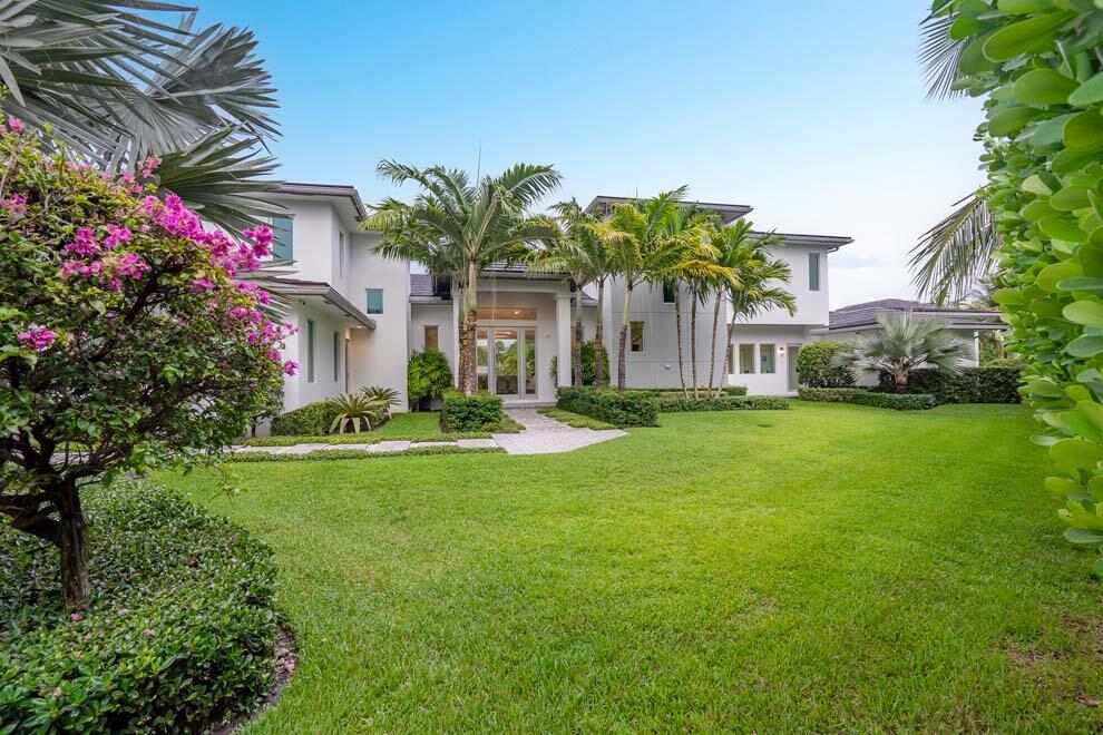 Designer estate with over 220 feet of waterfrontage, incredible views, protected dockage, and private beach access. Designed to perfection and situated on an elevated lot, the residence is offered turnkey, fully furnished. Features include six total bedrooms with first-floor master suite; VIP guest suite with kitchen; office/bedroom with full bath and three additional en suite guest rooms. Enjoy the covered loggia; summer kitchen; pool with overflow spa; and 50 foot dock with easy access to the ocean via nearby Inlet. Voluntary Homeowner's Association offers access to the private beach house with kitchen, showers; bathrooms and room for gatherings. Built in 2018, the current owner has added many designer and custom features. Enjoy waterfront living in this exquisite and private estate.