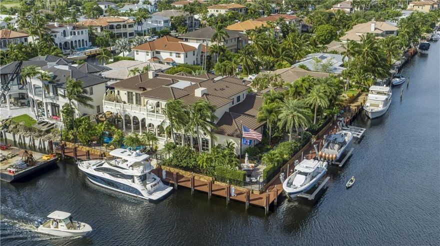 UNPARALLELED ESTATE HOME!! This totally remodeled, refreshed & elegant point lot masterpiece has 5 bedrooms, 7 full and 2 half bath, office/library, media room, grand scale living room w/ souring ceilings, triple saltwater aquarium, 3 fireplaces, elevator, formal dining room w/ wine cellar, amazing new kitchen w/ island and ate of the are appliances, opens to large family room & breakfast area plus awesome home theater. VIP stateroom on first floor, Master suite w/ lg sitting area up plus 3 additional bedrooms all w/ ensuite baths. Huge covered patio w/ summer kitchen, full cabana bath, fireplace, Disney style pool w/water features, multiple outdoor sitting areas w/ fountains and fire pit. 3 boat lifts and 270-ft of deep water for boats with room for 135"yacht! Perfect yachting home base