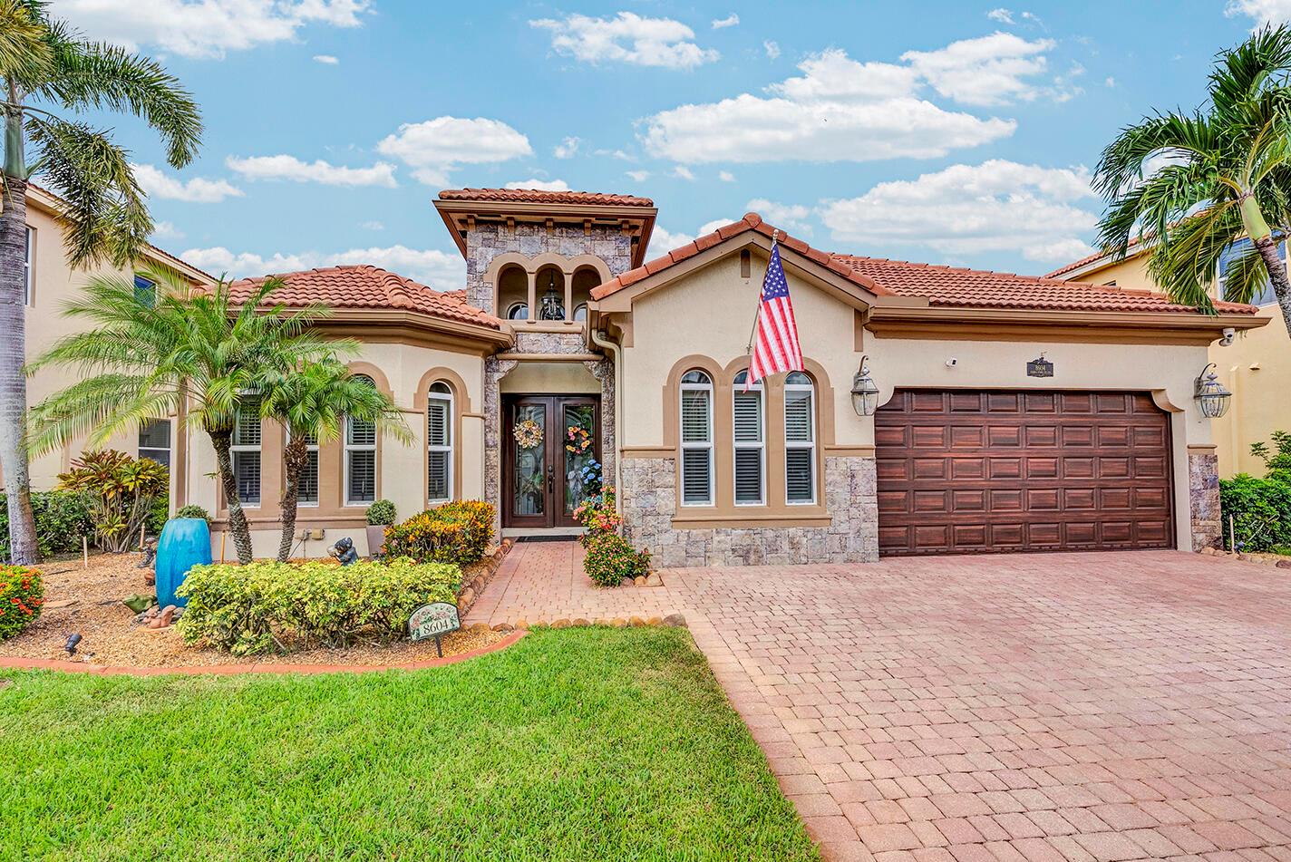 Resort-Style Living Awaits in this family friendly neighborhood! Stunning and spacious 3BR/2.5BA with custom stone facade, custom windows and architectural tower. Flexible layout with den (builder-converted 3rd garage) & office--both easily convertible to bedrooms for a 4th & 5th bedroom option. Gourmet kitchen features quartz countertops, new appliances, double oven, gas stove, pot filler & pull-out drawers. Built in wine cooler. Spacious bedrooms and updated bathrooms. Outdoors, enjoy a screened pool with waterfall, outdoor kitchen, travertine deck, propane fire pit, motorized roll out sun shade and free-standing jacuzzi. Impact windows throughout, motorized custom blinds, 2 AC units & new water heater . Custom garage cabinetry adds excellent storage.