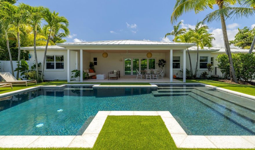 Beautifully renovated and designer furnished, this turnkey property offers relaxed coastal living on a coveted intracoastal block in the popular ''SoSo'' neighborhood of West Palm Beach. Designed for effortless indoor-outdoor living, the single-level layout features a light-filled great room with nano sliding glass doors that open to a covered outdoor loggia overlooking a lush garden and sparkling pool. The updated kitchen includes a charming breakfast nook, perfect for casual mornings. The large, open dining room is surrounded by windows and sweeping views of the front garden. The desirable split floor plan features a spacious primary suite with walk-in closet and two inviting guest bedrooms...MORE