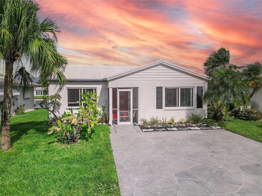 This charming 2-bedroom home boasts stunning waterfront views, a bright sun lit interior with an abundance of natural light, and modern finishes throughout! Enjoy peace of mind with full hurricane protection provided by ALL IMPACT WINDOWS and doors. The interior features newer vinyl flooring throughout, updated kitchen with granite counter tops, and stainless steel appliances, creating a modern space perfect for relaxing or entertaining. Situated in a vibrant 55+ community, this home offers access to a clubhouse, community pool, and a serene lifestyle by the water with a low HOA of only $88 a month.