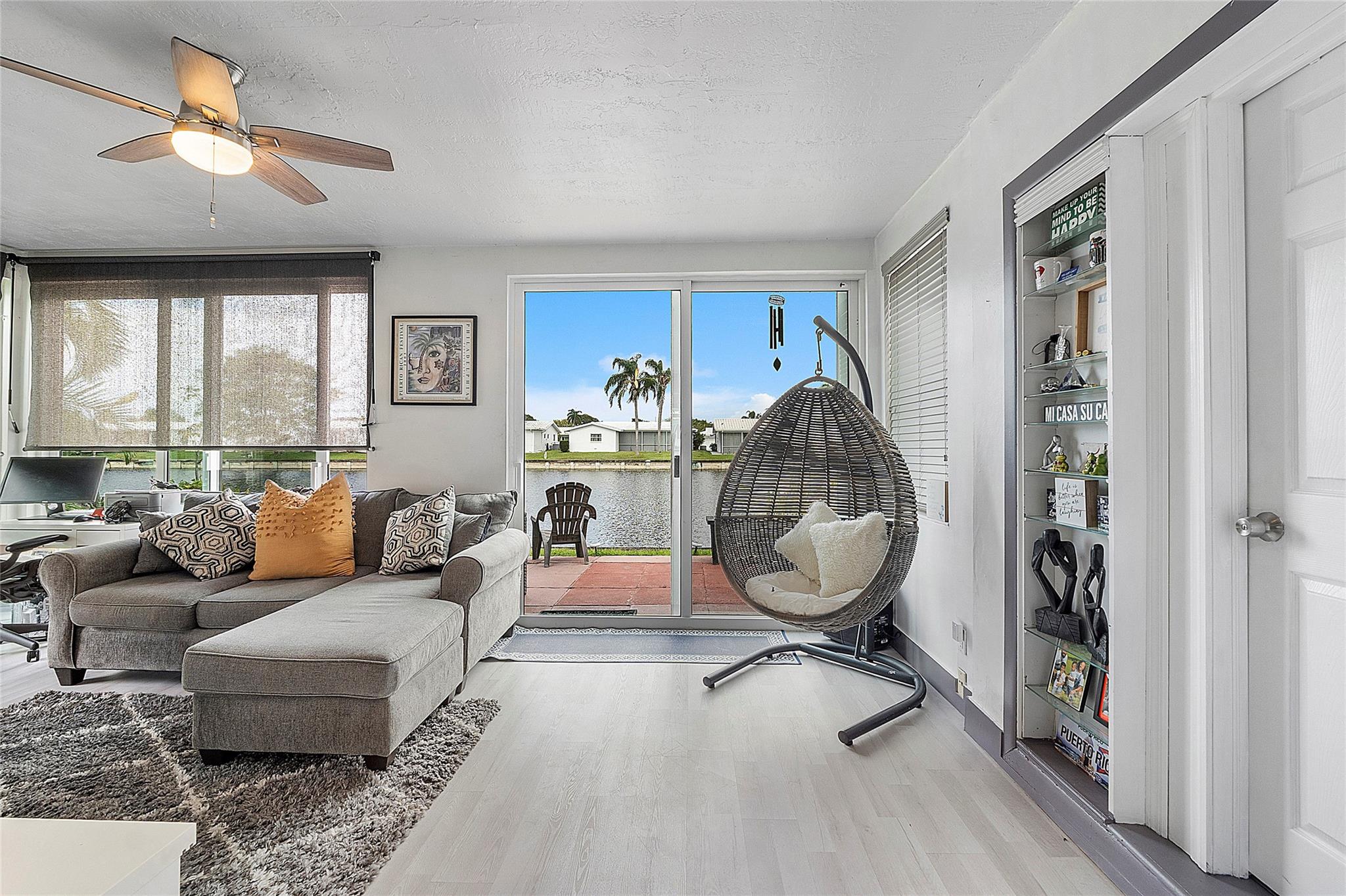 This charming 2-bedroom home boasts stunning waterfront views, a bright sun lit interior with an abundance of natural light, and modern finishes throughout! Enjoy peace of mind with full hurricane protection provided by ALL IMPACT WINDOWS and doors. The interior features newer vinyl flooring throughout, updated kitchen with granite counter tops, and stainless steel appliances, creating a modern space perfect for relaxing or entertaining. Situated in a vibrant 55+ community, this home offers access to a clubhouse, community pool, and a serene lifestyle by the water with a low HOA of only $88 a month.