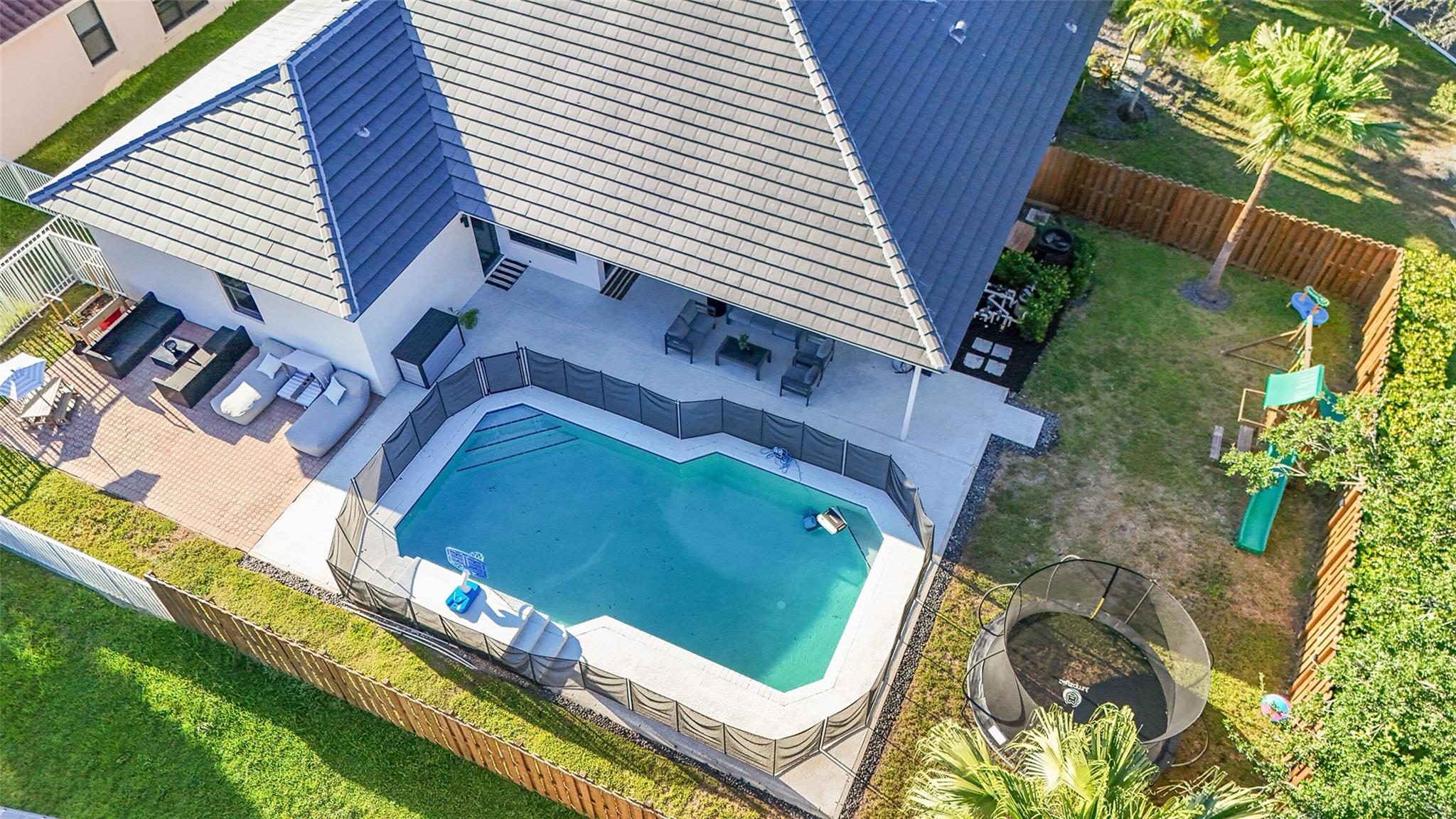 Welcome to this stunning corner-lot residence in the exclusive gated community of The Estates of Sterling Lake in Davie. This beautifully upgraded 4-bed, 2.5-bath pool home offers the perfect blend of luxury, comfort, and serene lakefront living. Situated on a prime corner lot of over 10,500 SQFT lot with lush landscaping and serene views of the lake. Backyard features a brand-new fence, offering privacy & security, along with sparking heated pool and huge entertainment space for your fun summer gatherings. New 2025 Roof and all impact windows and doors. Step inside to find porcelain wood floors, custom interior Italian doors and new laundry room, updated kitchen with quartz island and high-end finishes. New Ac 2024, 2-car garage with ample driveway space. This home checks all the boxes.
