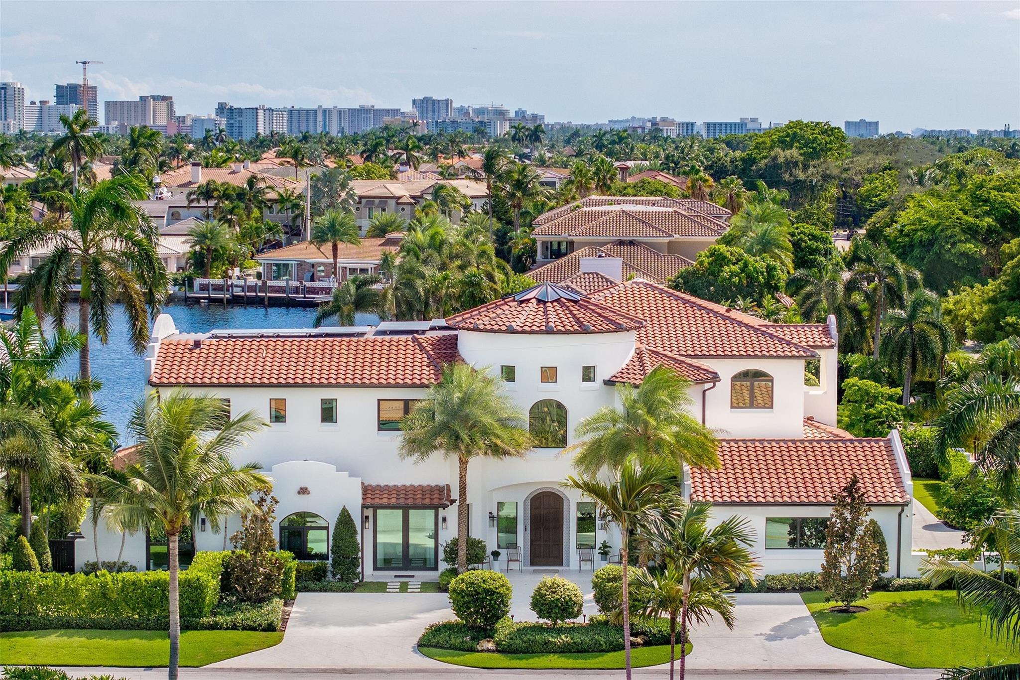This 2022 one of a kind masterpiece is straight out of an architectural magazine designed by California designer, Lisa Mayock. This 8 bedroom, 7 full baths and 2 half bath estate is situated on an oversized corner lot with expansive water views. The home boasts all exotic natural stone, hard woods, custom fishes & skylight, Gaggenau/Sub-Zero/Meile appliances, & custom built-in dual control wine cooler. The home includes two fully equipped laundry rooms, a butlers pantry, pilates/gym studio, club room with wet bar, media room and office with private exterior access, and "mid-night" kitchen. Exterior has cabana bath, outdoor shower, custom putting green, gated driveway with 4 car garage and EV chargers, full summer kitchen & retractable screens. No fixed bridges, 10 mins to ocean.