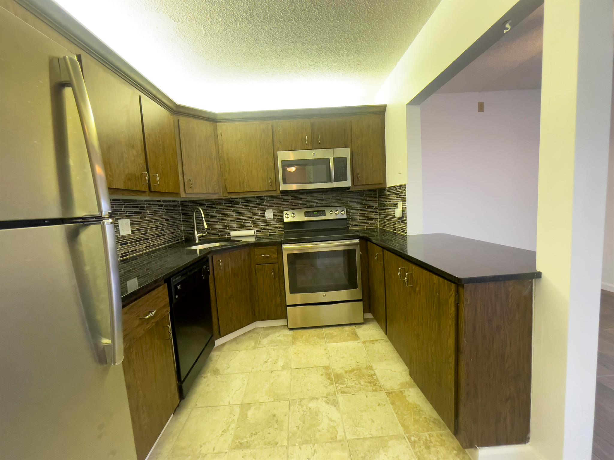 Updated condo for seniors, one of the lowest assoc payment around, wonderful maintenance, deed it parking spot, New A/C, Water Heater, Electric Box inside, paint, flooring, kitchen appliances stainless steel, just bring your belongings.