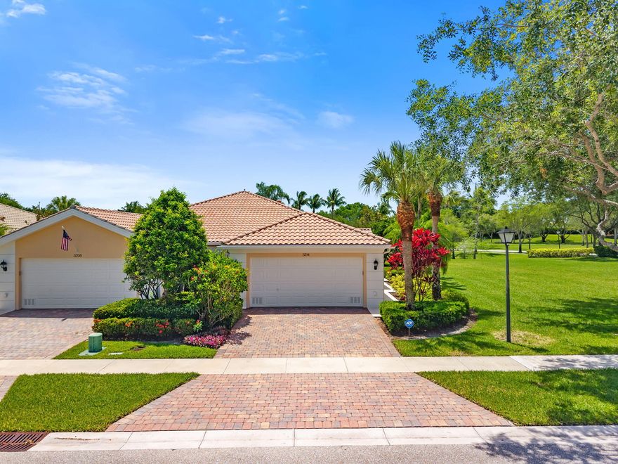 Welcome home to one of the best lots in VillageWalk! Situated on a prime oversized corner lot with expansive green space and tranquil waterfront views, this Divosta-built Capri III villa offers a rare combination of privacy, open scenery, and peaceful South Florida living. With wide open greenbelt areas surrounding the home, there is plenty of space for kids to play, pets to roam, or simply to relax and enjoy the serene lakefront setting. This beautifully maintained 2-bedroom, 2-bath single-story villa features an open and spacious split-bedroom floor plan designed for comfortable everyday living and effortless entertaining. The upgraded kitchen is complete with granite countertops, breakfast bar seating, abundant cabinetry, and flows seamlessly into the dining and great room areas. The primary suite offers private lake views along with an en-suite bathroom, while the guest bedroom is thoughtfully positioned for privacy. Tile flooring runs throughout the home, and a brand-new upgraded front door adds to the home's curb appeal.  Enjoy Florida living at its finest from the large screened patio overlooking the expansive green space and sparkling lake views — a truly special outdoor setting rarely available in the community.  Located within the gated community of VillageWalk, residents enjoy resort-style amenities including two pools, tennis courts, basketball courts, fitness center, community clubhouse, café, and beautifully landscaped grounds. Centrally located near shopping, dining, top-rated schools, and everything Wellington has to offer, this home is a must-see!