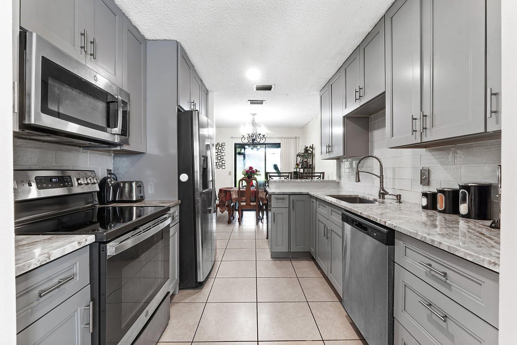 Photo of 1595 Woodbridge Lakes Circle, West Palm Beach, FL 33406 (MLS # B26080340)