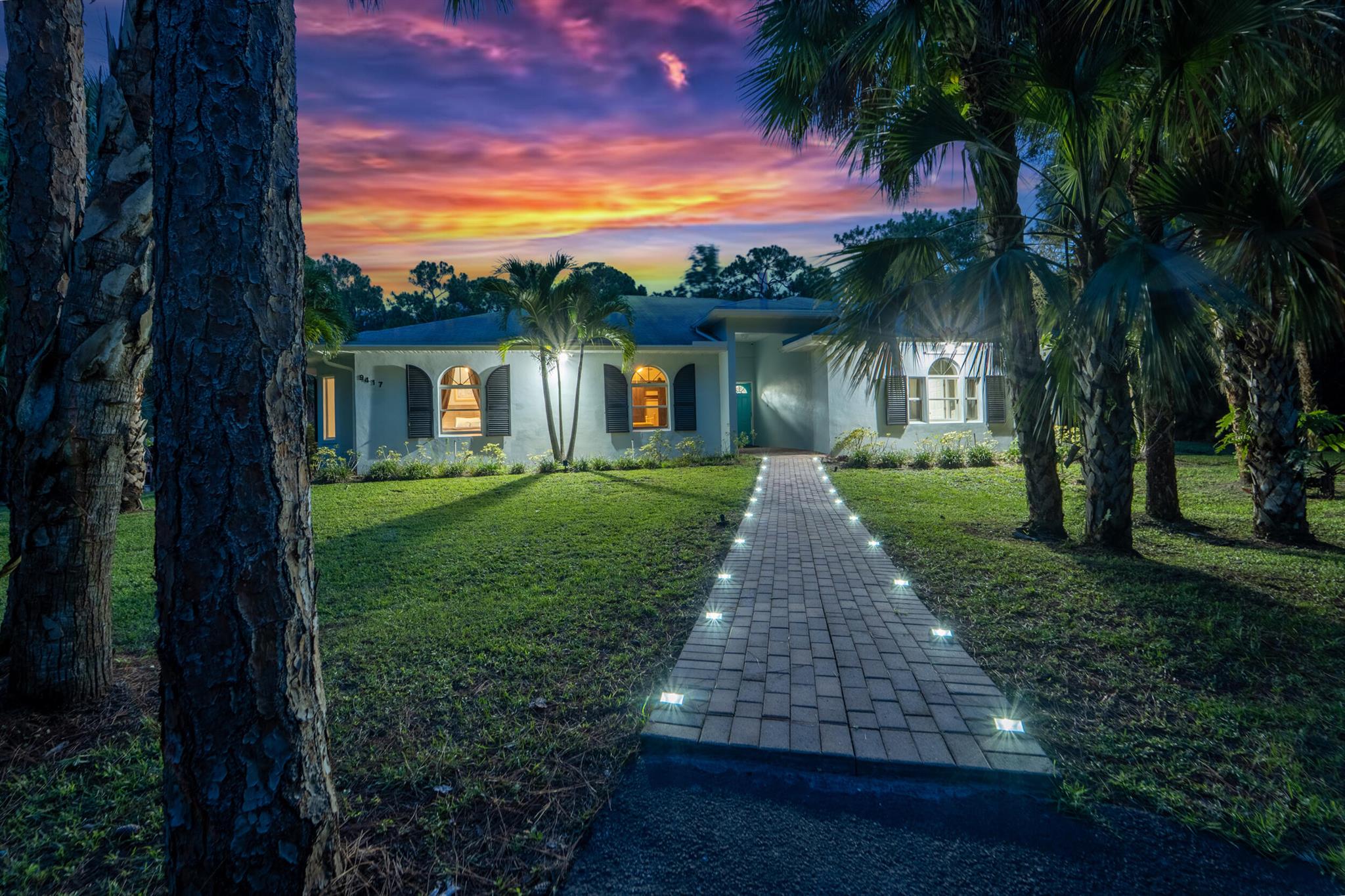 Nestled in the heart of picturesque Jupiter Farms, Florida this magnificent 2.5 acre estate offers unparalleled private luxury and comfort, embodying the best of Southern Florida living, This sprawling 4,767 sq ft ranch home is designed for grand living and entertaining, featuring an open- concept great room with a dual -sided fireplace shared by the formal dining room, The spacious, open-concept kitchen includes an large eating are with additional eating bar perfect for entertaining or hosting large family gathering, With a beautiful primary bedroom features an ensuite with oversized shower and dual sinks, there is also two additional bedrooms that have views of the pond. A sparkling heated concrete pool, this residence provides ample space for relaxation.