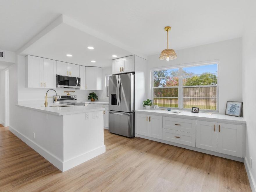 Beautifully remodeled 2 bedroom 1.5 bath first floor true corner unit.  The kitchen has been completely updated and features ample cabinetry, quartz countertops, a pot filler, spice cabinet and lazy Susan, along with newer stainless steel appliances.  Enjoy luxury vinyl flooring throughout and modern zebra blinds. Additional upgrades include central AC, a newer water heater, and updated electrical system.  Both bathrooms have been tastefully renovated, and the enclosed patio provides the perfect space to relax and unwind.  Located 15 minutes from the beach, the community has a theater, gym, pickleball courts, buses, fitness, and pools. Don't miss out on this update Condo!! Its a must see!!