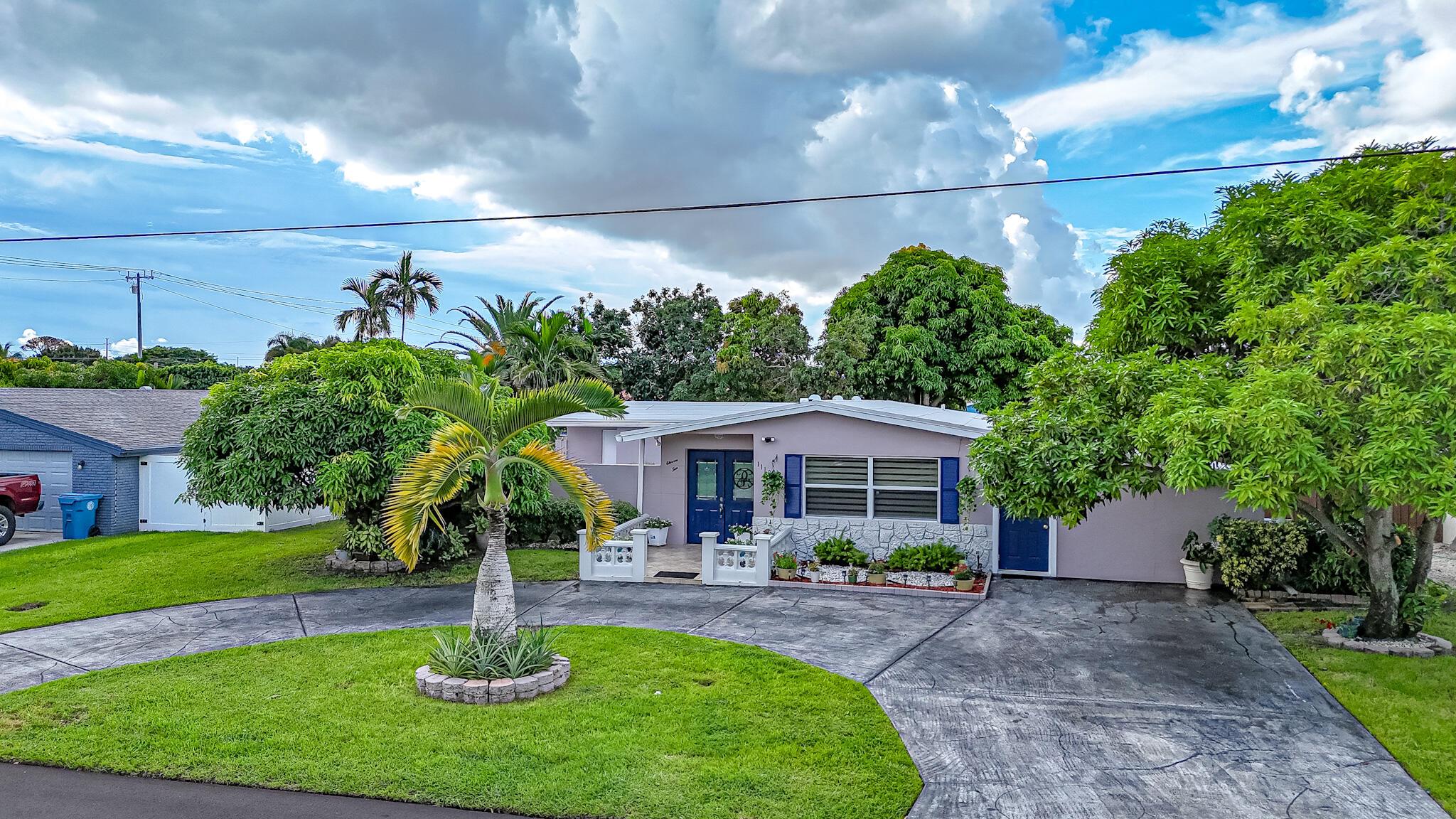 Enjoy Florida living at its best in this no-HOA waterfront home! Offering 4 bedrooms and 3 baths, including a private efficiency-suite with its own bed and bath--ideal as an office, guest space, or game room. Recently updated with a 2024 roof, impact windows, and fresh paint, this property is move-in ready. Inside, you'll find hardwood floors, crown molding, a spacious living room, a stunning master bathroom, and a kitchen with quartz countertops and solid wood cabinets. Outside features a sparkling pool with expansive deck and a private dock with lake access--perfect for boating, fishing, or relaxing by the water. Walking distance to Caloosa Park, Ocean Ridge Beach, and endless shopping!