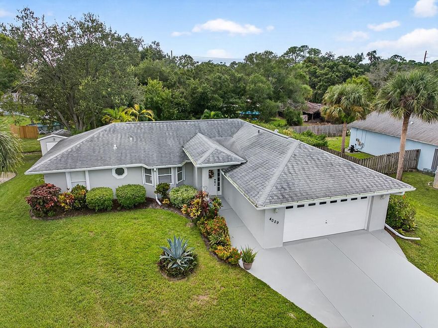 Welcome to your Private Tropical Retreat in desirable Treasure Trail Vero Beach! A rare blend of timeless elegance, comfort, and privacy. This impeccably maintained 3 bedroom, 2 bath, 2 car garage w/ storage shelving CBS home is perfectly situated in one of Vero Beach's most sought after LOW HOA neighborhoods, known for its charm and tranquility. Crafted with enduring CBS construction. Not wood frame! This home rests on a lush, oversized fenced in lot framed by mature, colorful and manicured landscaping, creating a peaceful sense of seclusion. Follow the beautifully paver stone walkway to the expansive screened lanai, ideal for morning coffee, al fresco dining, or evening gatherings under the palms. Inside, a thoughtfully designed split-bedroom