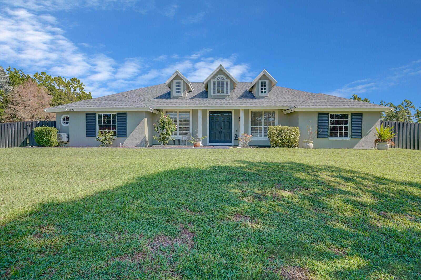 Welcome to 17271 82nd Rd N! This beautifully maintained 4 bedroom, 2 bathroom home sits on over an acre in Loxahatchee and comes with a massive 1,657 sq ft CBS shop/garage that includes a potential 3rd bathroom--perfect for future guest space, a workshop, or business use. Inside, you'll love the open layout with soaring ceilings, split-bedroom design, and a modern kitchen featuring stainless steel appliances, and a large center island. The primary suite offers a walk-in closet and spa-style bath with soaking tub. Outside, enjoy wide-open green space with plenty of room for a pool, garden, or horses. With no HOA, oversized 2-car garage, and space for your boat or RV, this property delivers the freedom of country living while being close to Northlake, Southern, shopping, and schools.