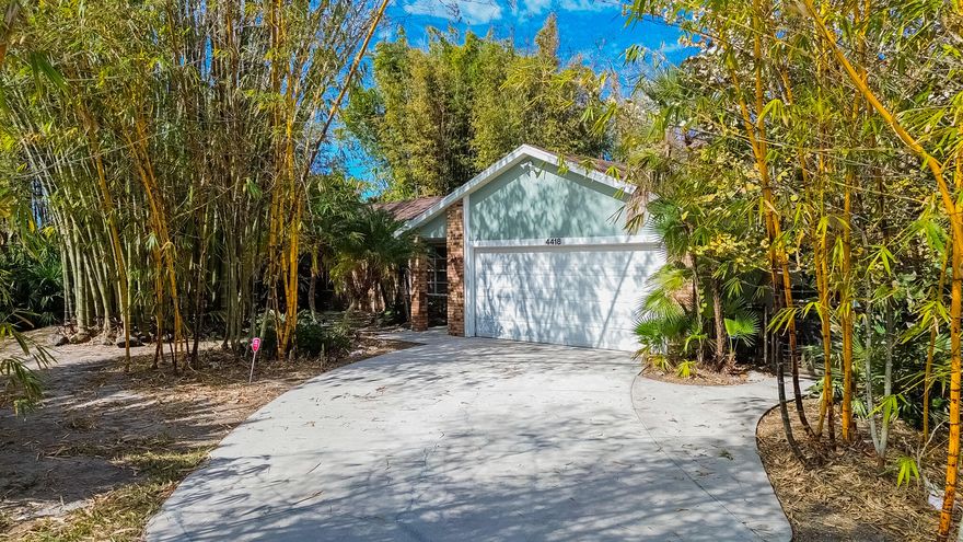 Discover your private tropical oasis in this move in ready 3/2/2  pool home! Perfectly situated on a spacious corner lot, the property is enveloped by mature, tall bamboo for ultimate natural privacy. The modern interior features tile flooring throughout and an updated kitchen complete with elegant granite countertops and sleek stainless steel appliances. Step outside to your personal retreat: a covered lanai and screened-in pool area designed for entertaining, featuring a convenient outdoor shower. With a 2-car garage, a newer roof (2022), and no HOA fees, this move-in-ready gem offers the perfect blend of secluded Florida living and contemporary comfort.