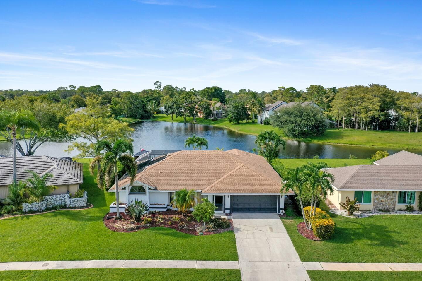 Discover the allure of this stunning 5 - bedroom, 3-bathroom home in the sought-after Sugar Pond Manor, boasting the picturesque water view you've been longing for! Step into a residence where the master suite, dining room, and kitchen seamlessly connect to the expansive covered and screened pool/patio area, creating a perfect setting for memorable gatherings with family and friends. Indulge in the master suite's amenities, a separate shower, and a generous walk-in closet, providing a luxurious retreat. The well-appointed kitchen showcases granite countertops, modern appliances, and an open layout to the family room, ensuring a harmonious blend of style and functionality. Enjoy the outdoors with a solar-heated pool, providing year-round comfort
