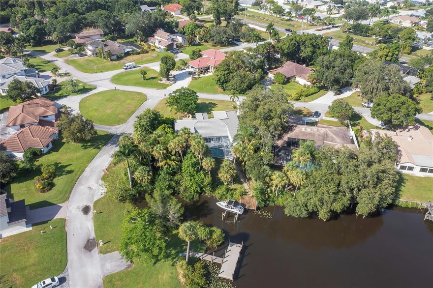 SELLERS ARE MOTIVATED!!! AN EXTENSION WAS DONE MAKING THIS PROPERTY A 4/3. Come experience and make it yours, this piece of paradise nestled in a corner lot by the Saint Lucie River. A beautiful single family home with screened in pool/jacuzzi, a private dock with a $25K boat lift providing ocean access through Saint Lucie river in just 45 minutes to reach the ocean. Custom made cabinetry in the formal dinning room and a beautiful office with great taste! Awesome 4 bedrooms, 3 baths corner lot with fruit trees. Open floor concept with a eat in kitchen with custom made cabinets, granite countertops. Marble floors throughout, and crown molding in main areas. Master bedroom with walk in closets, separate shower stall and beautiful tub to enjoy.