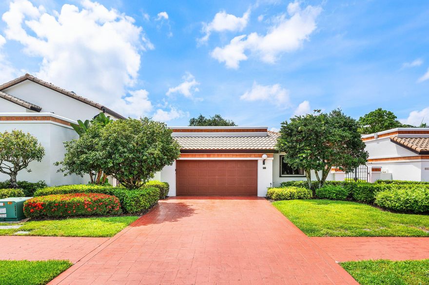 Spacious and beautifully maintained home in the gated enclave of Villa Flora at Boca Pointe (optional membership available). The manicured garden entry creates an inviting first impression. Inside, the split-bedroom floor plan features a spacious family room overlooking the lanai and  backyard greenspace. Volume ceilings and abundant natural light enhance the home's open, airy feel.  Well appointed primary suite with an updated bathroom and walk-in closet. Updated guest bathroom with double vanity. Two car garage.  Pet friendly community. Ideally located in desirable Central Boca, just minutes from A-rated schools, dining, shopping, and the beaches. Boca Pointe offers gated security, beautifully maintained grounds, and optional memberships for golf, tennis, fitness, and social amenities.