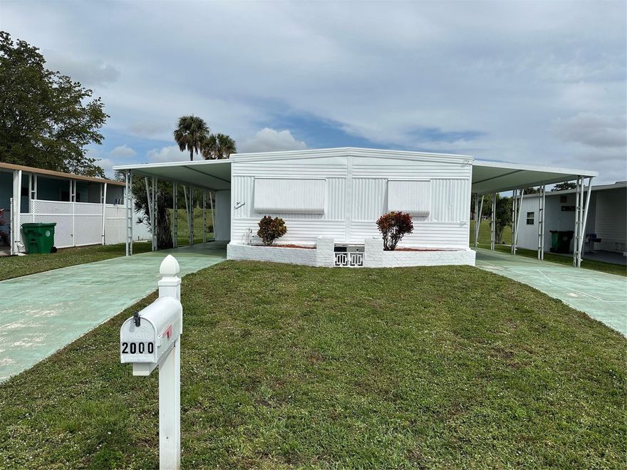 Rare find! Beautiful double wide home on the golf course with views of the first hole of Davie Golf Club. Home is being sold furnished and features many updates along with two covered driveways, shed, washer & dryer. This is the only home available on the golf course. Won't last long!