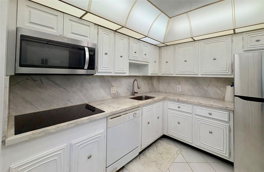 Experience spacious living in this 1BR/1.5BA condo in Palm Aire featuring a large bedroom with an en-suite bath and walk-in closet. Relax on your screened balcony with peaceful views of lush foliage and the golf course. The kitchen was refreshed in 2025 with new quartz countertop, cooktop, microwave, and refrigerator. Enjoy 3 pools, walking trails, golf and a resort style atmosphere.  Minutes from shopping, dining, and Harrah’s Casino with TopGolf. Just 6 miles to the beach with easy I-95 access. Includes cable/high-speed internet, secure lobby, and extra storage. Sold AS IS with Right to Inspect.