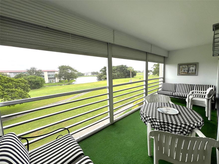 Imagine Sipping your Coffee Enjoying this Wide WATER/GOLF VIEW In Every Direction on the Screened Patio with ROLL-UP SHUTTERS then Enjoy the Village POOL IN FRONT of the Building. TURN KEY FURNISHINGS INCLUDED Plus TILE and LAMINATE FLOORING THRU-OUT Except the Living Room Plus UPDATED KITCHEN CABINETS and COUNTER with BOTTOM FREEZER REFRIGERATOR. ASSOCIATION REQUIRES ONE OCCUPANT 55+ WITH 20% DOWN AND WYNMOOR INCOME FORMULA AND A CREDIT SCORE OF 700 PLUS $250 REFUNDABLE MOVE-IN FEE. Information Deemed Reliable but, Not Guaranteed. BUYER'S AFFIDAVIT FOR FIRPTA WAIVER OF WITHHOLDING FOR FOREIGN SELLER REQUIRED WITH OFFER.