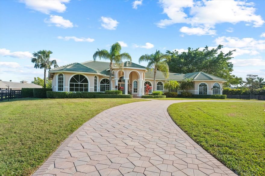 Just steps from the horse show within the Saddle Trail community in Wellington, Florida, this exceptional property embodies the pinnacle of luxury equestrian living. Set on 4.47 expansive acres, the estate features a beautifully designed 4-bedroom, 4-bathroom pool home that seamlessly blends sophisticated amenities with the serene charm of equestrian life. Equestrian enthusiasts will be delighted by the state-of-the-art 18-stall center-aisle barn and the newly redone geo-fiber main ring and lunging ring, ideal for jumping and dressage, seven large and raised paddocks, featuring high-quality fencing, ensuring both beauty and functionality. Outside, a heated pool provides the perfect retreat for relaxation. Designed for effortless entertainment, the home offers a spacious eat-in kitchen,