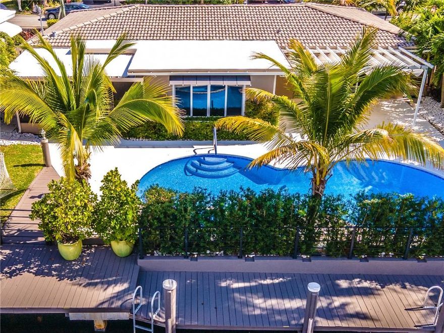 Once in a lifetime opportunity to own one of the premiere waterfront homes in East Wilton Manors.  Current owner is a General Contractor and has  rebuilt this home from the ground up.  Custom chef's dream kitchen with 5 burner gas range, high-end SS appliances, beverage center, Italian granite countertops, custom cabinetry.  Outdoor SS kitchen with gas grill. Covered outdoor patio, extensive landscaping, 75' of water frontage and dock, with additional floating dock.  Impact windows and doors throughout, indoor laundry room, custom blinds throughout, whole house generator, whole house water filtration system, whole house security system, custom mosaic pool, original polished terrazzo floors, 3 bdrms/3 full baths. Total SqFt, & Living SqFt from Tax records & owners, all measurements are approximate, subject to error, omission & changes without notice. All info must be confirmed by buyer, if not accurate, seller & listing office are not liable. If a buyer default, cooperating broker shall not participate in retained deposits paid to listing broker, commissions subject to successful closing & title transfers.