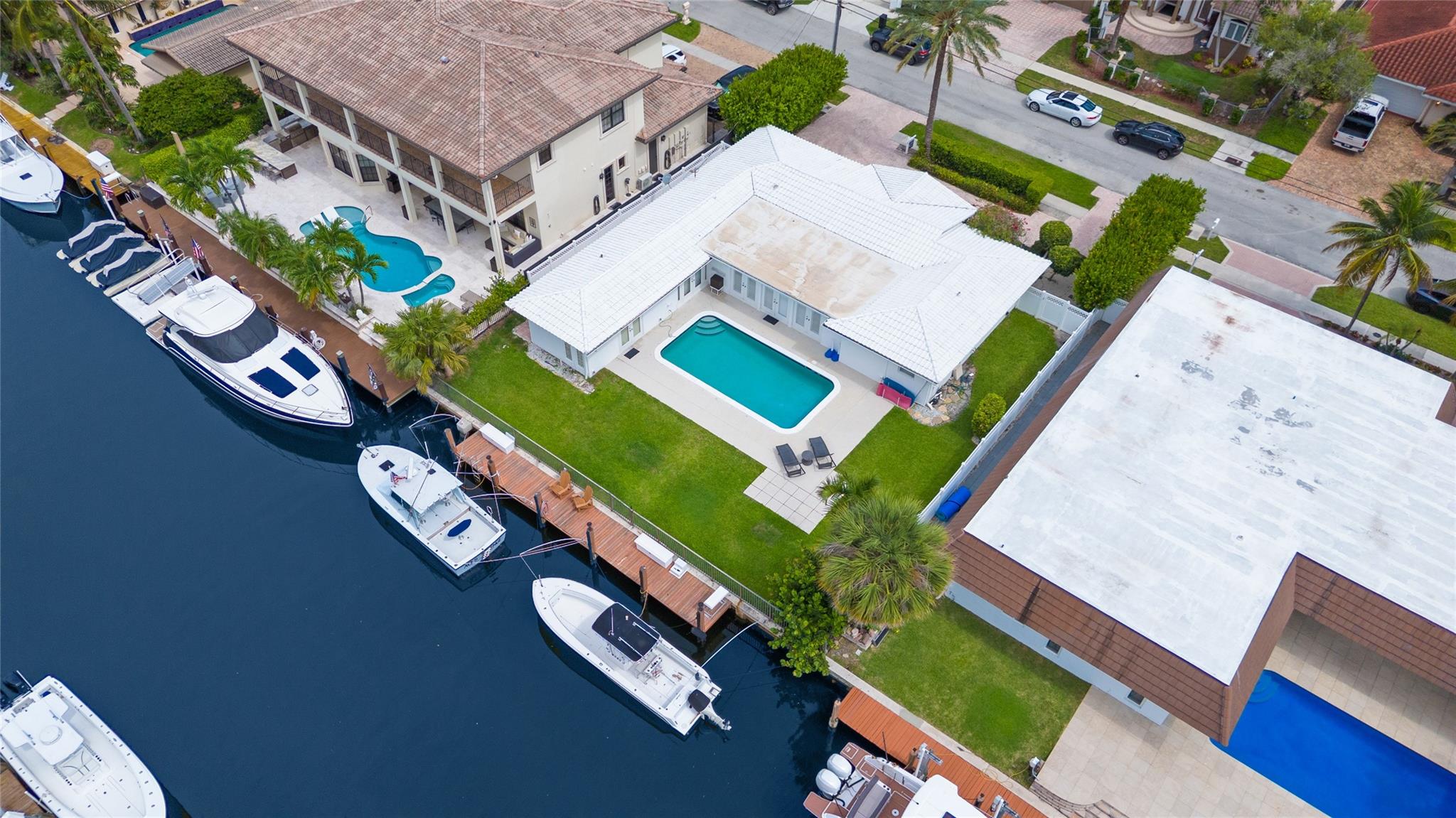Discover this charming waterfront ranch home in the prestigious community of Lighthouse Point. 80 ft. of water frontage (80x110). Featuring 3 bedrooms, 2 bathrooms, and 2,073 sq. ft. of living space on an 8,800 sq. ft. lot, this property boasts a sparkling pool and private dock, making it an exceptional find for boating enthusiasts or those seeking waterfront living. With direct ocean access and no bridges, it’s a boater’s dream. The backyard offers southern exposure, providing sun for the pool and outdoor space. Priced to sell, this home offers a unique opportunity to build your dream home or serve as a strong investment. Enjoy serene waterfront views, the convenience of docking a boat steps from the backyard, and the added luxury of your private pool, perfect for relaxing or entertaining