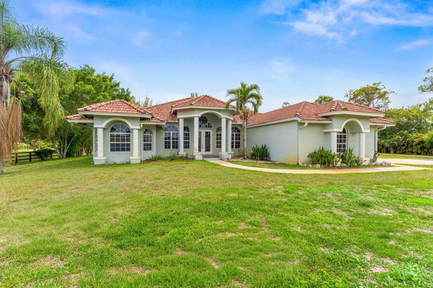 Charming equestrian estate offering exceptional amenities for horse enthusiasts. The grounds are thoughtfully designed for equestrian use, featuring an eight-stall barn complete with a tack room, comfort flooring in all stalls, electricity, water, and a built-in fly-spray system. A spacious 70' x 156' riding arena provides ample room for training and exercise, while a dedicated wash station, utility shed, and abundant storage support efficient day-to-day operations.